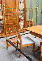 A Victorian Brass Double Bed, with reeded finials, on large pot castors and complete with irons,