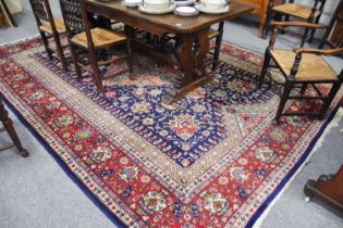 Tabriz Carpet, the indigo field of angular vines and flowers centred by a coral pink medallion