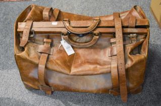 A Large Tan Leather Gladstone Type Overnight Bag, with buckled straps, lock and brass studs