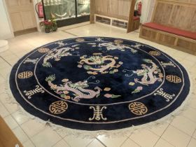 Chinese Carpet, the deep indigo field centred by a dragon chasing a flaming pearl surrounded by