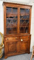 A Regency-Style Mahogany Bookcase, reproduction, with glazed upper section, the two drawers with