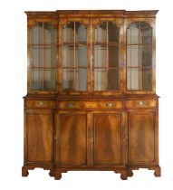 A 1920's/30's Walnut Breakfront Bookcase, the moulded cornice above a plain frieze and glazed