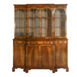 A 1920's/30's Walnut Breakfront Bookcase, the moulded cornice above a plain frieze and glazed