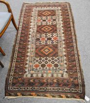 Unusual Baluch Rug, the compartmentalised field of serrated guls and latch hook medallions framed by