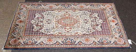 Kashmir Silk Rug, the ivory field centred by a cusped medallion, framed by indigo floral borders,