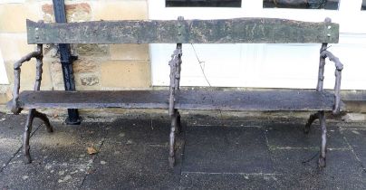 A Victorian Cast Iron Garden Bench, late 19th century, with later painted arm supports as tree