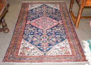 Hamadan Rug, the indigo field of flowers and plants centred by a serrated medallion, framed by