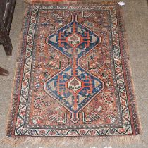 Pair of Saroukh Mats, each with a brick red field centred by pale lemon floral medallion enclosed by