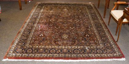 Indian Rug, the deep terracotta field with an allover design of scrolling vines and flowers enclosed