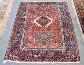 Karabagh Rug, the rose pink field with three medallions enclosed by wide indigo borders, 188cm by