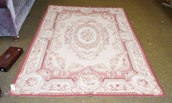 Needlepoint Rug of Aubusson Design, the cream field centred by an oval floral panel, surrounded by