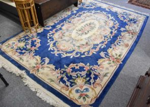 Chinese Carved Carpet, the mid-blue field with central floral medallion enclosed by scrolling vine