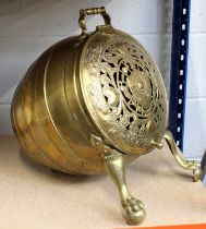 A 19th Century Dutch Brass Coal Bucket of Tilted Barrel Form, on two paw feet, with a hinged pierced