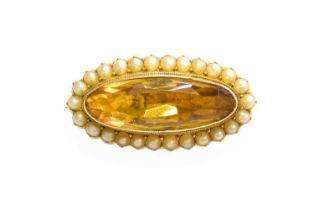 A Citrine and Split Pearl Brooch, the oval cut citrine in a yellow rubbed over setting, within a