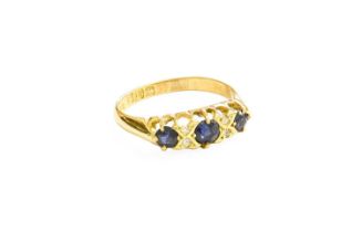 An 18 Carat Gold Sapphire and Diamond Ring, three round cut sapphires spaced by pairs of old cut