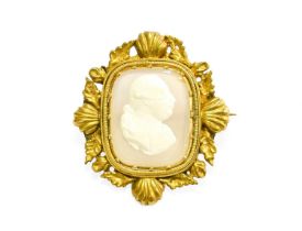 An Agate Cameo Brooch, the cushion shaped agate cameo in a yellow claw setting, within a shell and