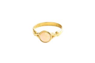 An 18ct Gold Opal Ring, the round cabochon opal in yellow rubbed over setting, to a fancy shoulder