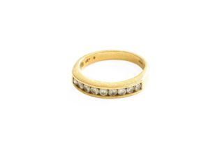 A Diamond Half Hoop Ring, nine round brilliant cut diamonds in a yellow channel setting, to a