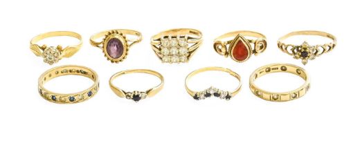 A Collection of Nine Various Rings, comprising a 9 carat gold sapphire and diamond wishbone ring (