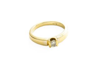 An 18 Carat Gold Diamond Solitaire Ring, the round brilliant cut diamond in yellow tension