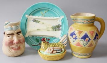 Sarreguemines Face Jug, a Majolica asparagus plate, hen egg basinet and a jug (4)