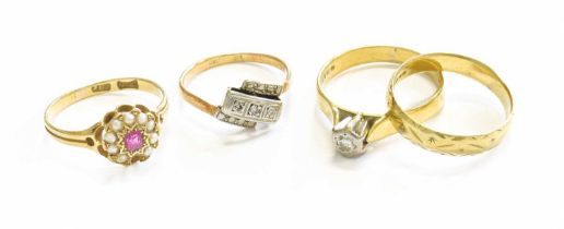 Four Rings, comprising of an 18 carat gold band ring, finger size N1/2; a diamond three stone