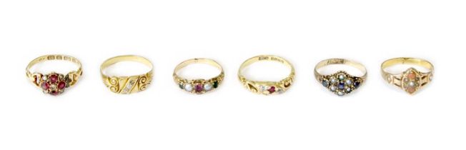 Six Rings, comprising of an 18 carat gold ruby and diamond three stone ring, finger size L1/2; a