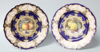 A Pair of Royal Worcester Fruit Painted Parcel-Gilt Plates, both signed R. Sebright, on cobalt