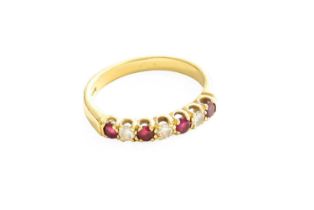 An 18 Carat Gold Ruby and Diamond Half Hoop Ring, four round cut rubies spaced by three round