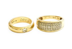 A 9 Carat Gold Diamond Solitaire Ring, the yellow band inset with a round brilliant cut diamond in a