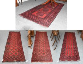 Afghan Turkmen Runner, the scarlet field with two columns of octagonal güls enclosed by