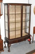 An Edwardian Mahogany Glazed Display Cabinet, with bow front on ball and claw feet, 115cm by 45cm by