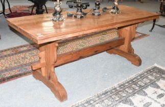 An Oak Refectory Table, of pegged construction, on a trestle base, 181cm by 69cm by 74cm