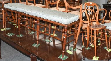 A 19th Century Turned Caned Long Stool, on slender turned supports, joined by similar stretchers