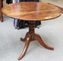 A George III Tripod Table, 87cm by 69cm Table top with visible nail head repairs across the full