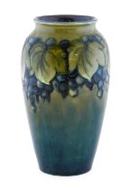 William Moorcroft (1872-1945): A Leaf and Berry Pattern Vase, on a celadon teal ground, impressed