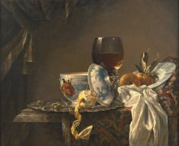 Manner of Willem Kalf (1619-1693) Dutch A still life of a silver platter with olives, a peeled