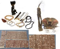 A Collection of Souvenir Artefacts from Papa New Guinea, comprising four Tapa (bark) cloths, each