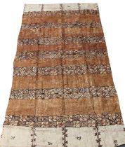 A Large Tongan Tapa (Bark) Cloth, the cream field decorated with panelled bands of geometric