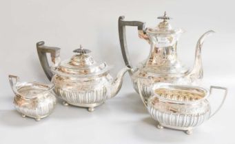 A Four-Piece Victorian Silver Tea and Coffee-Service, by Walker and Hall, Sheffield, 1898, each