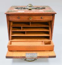 A Brass Mounted Oak Stationery Cabinet, early 20th century, ornamented with a mask to the top with