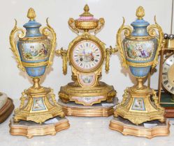 A French Gilt Metal Pink Porcelain Mounted Striking Mantel Clock, circa 1890, on a gilt wooden base,