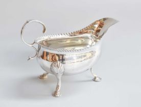 A George III Silver Cream or Sauceboat, by Wiliam Skeen, London, 1770, oval and on three shell-
