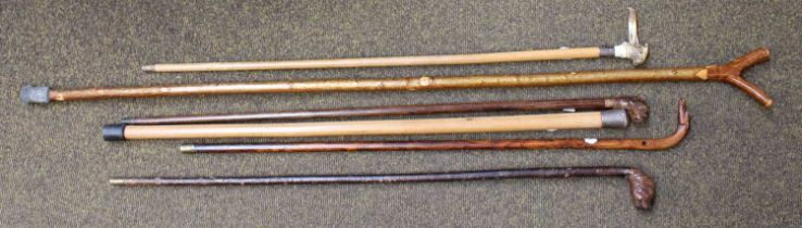 A Collection of Walking Sticks and Canes, one with a carved horn topper as a bulldog, a similar