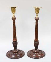 A Pair of George III Weighted Mahogany Candlesticks, with brass sconses, 36cm high (2) Generally