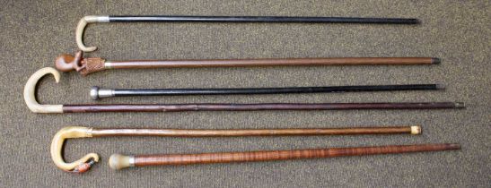 Six Walking Sticks/Canes, one cane with horn topper and silver collar, a similar walking stick, an