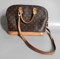 A Louis Vuitton Canvas Monogrammed Alma Bag, with tan leather handles and base, gilt metal mounts,