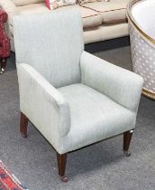 An Edwardian Upholstered Armchair, on square tapering supports on pot castors 62cm by 70cm by