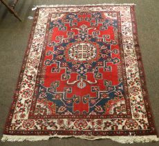 Tafrish Rug, the blood red field with central medallion enclosed by ivory borders, 198cm by 131cm