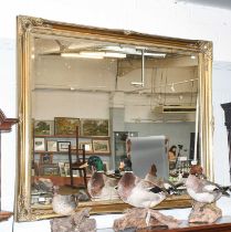 A Reproduction Gilt Framed Mirror, with bevelled plate, 129cm by 106cm